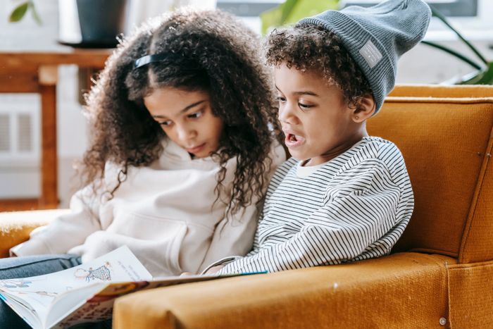 Two children reading a picture book together