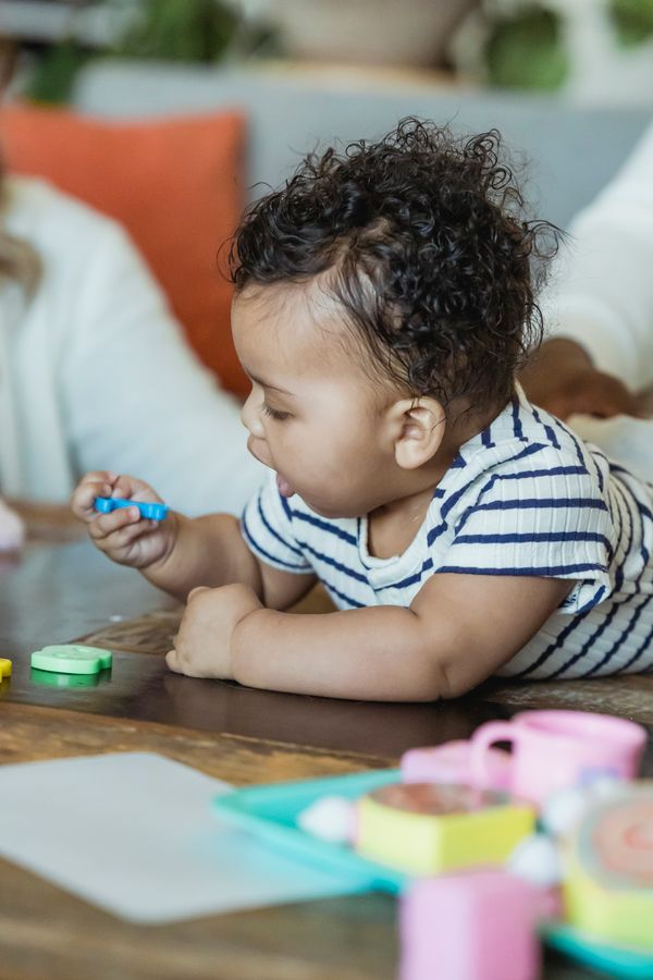 Toddler playing with shape toys